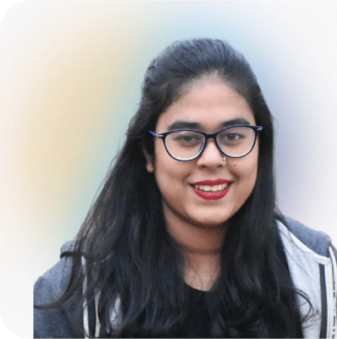 Fareeha, Marketing Associate with long dark hair, in hoodie, on a softly blurred colorful background